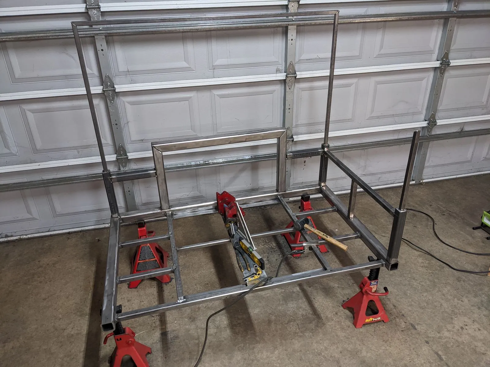 The bed sides and upper frame tacked together on top of the lower frame