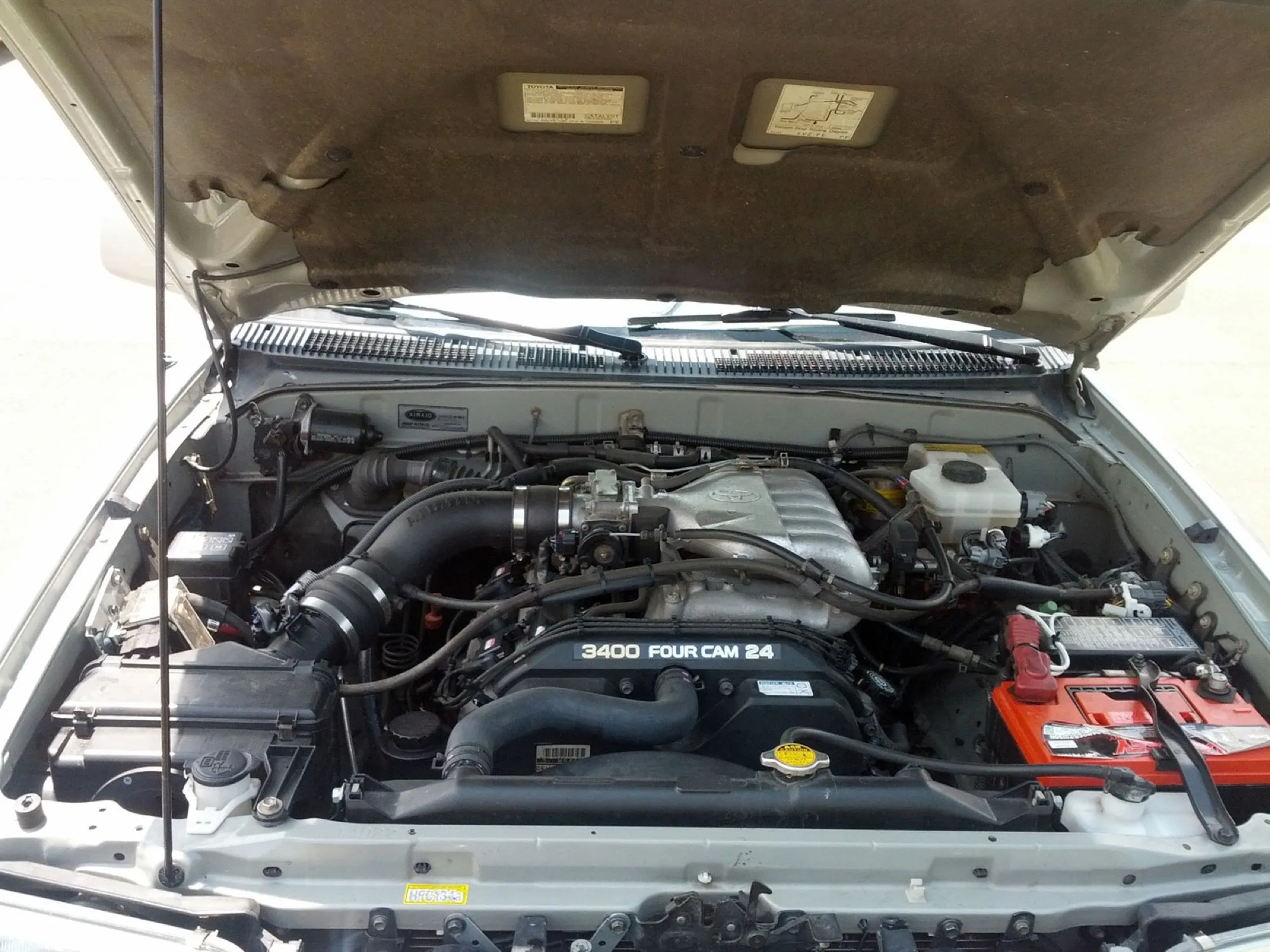Engine bay with the 3.4 litre V6, Airaid intake tube, and Odyssey battery