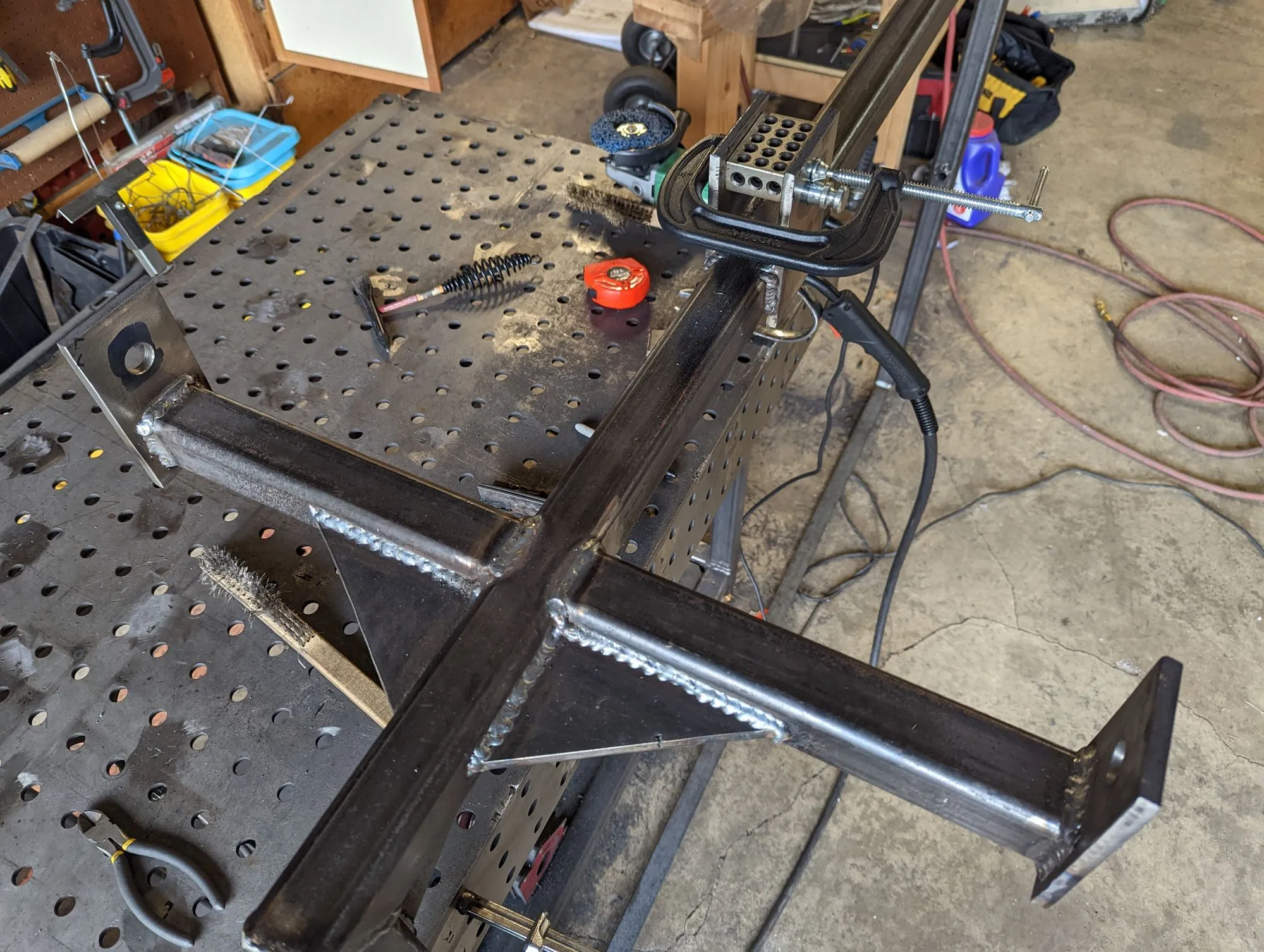 The fence puller’s cross-shaped base on the welding table