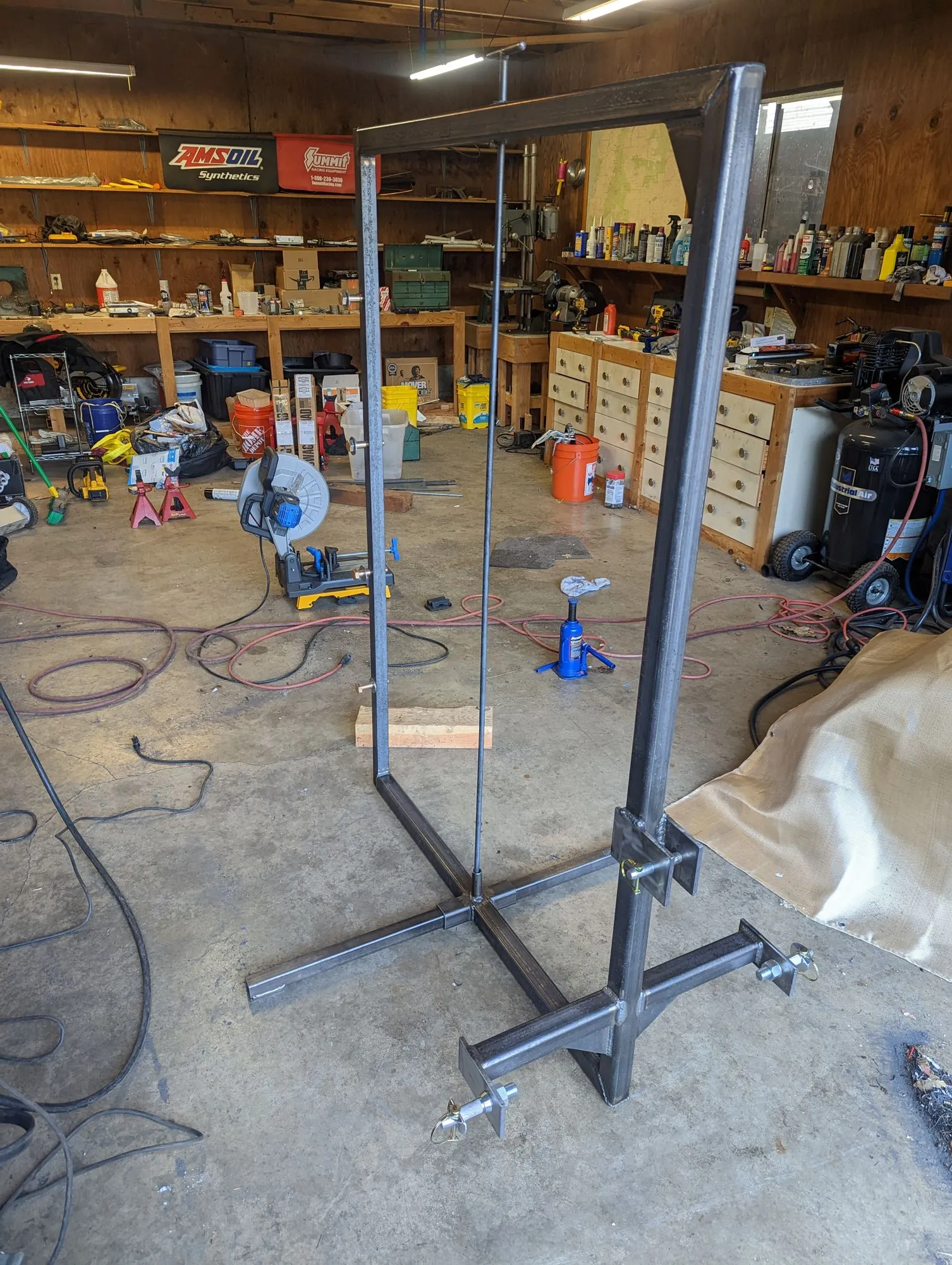 The fence puller’s tall frame standing in the shop