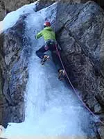 James ice climbing a frozen waterfall