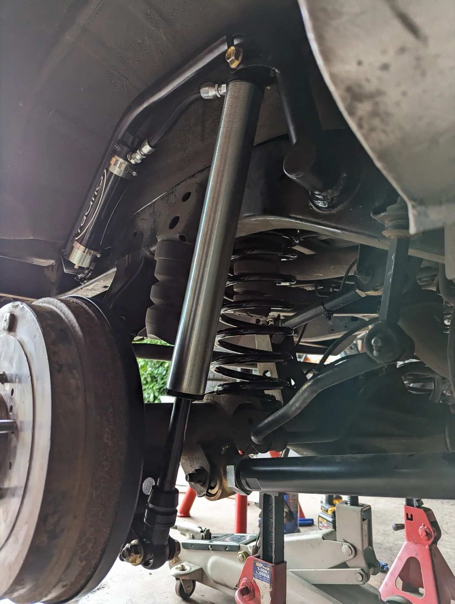 Rear Radflo shock on an FGB outboard mount, with the coil spring and tubular links behind it