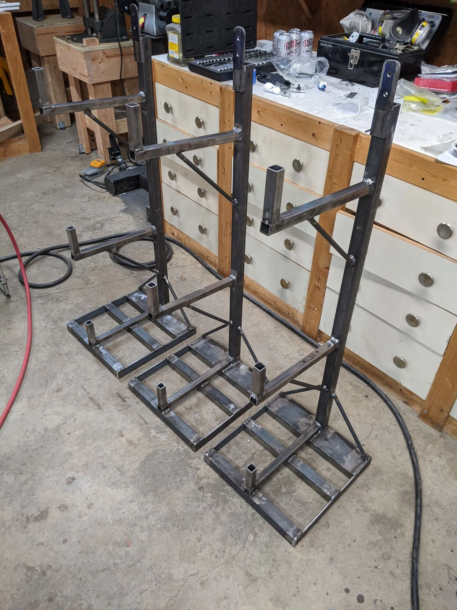 Three steel stands for the stock rack, before installation